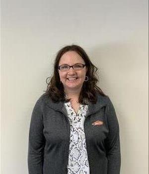 Pictured is our administrative assistant with a grey servpro sweater on. 